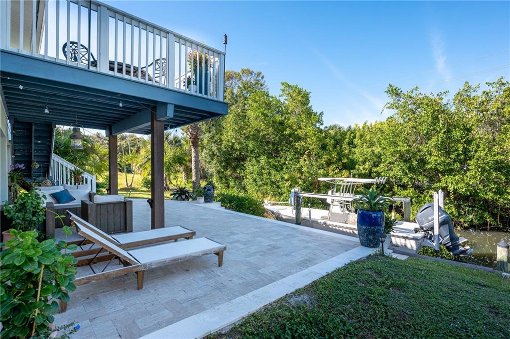 5440 95th Street Sebastian, FL 32958 - Photo 34 of 36 a view of a patio with a table chairs and a backyard