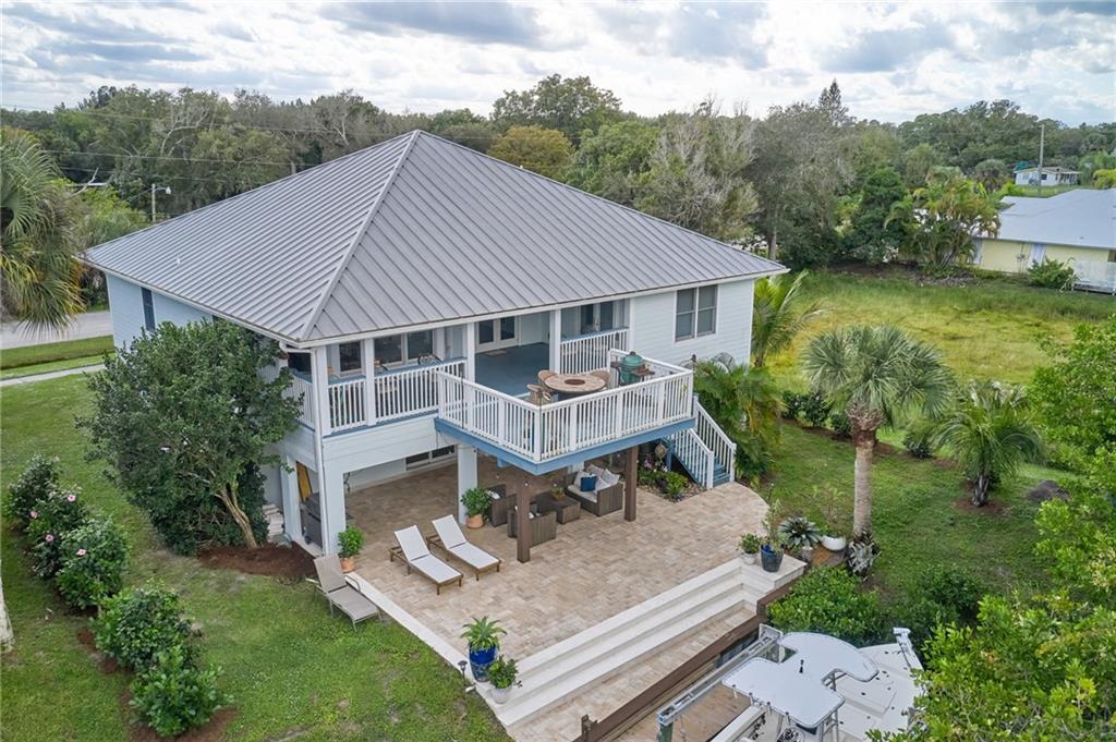 5440 95th Street Sebastian, FL 32958 - Photo 4 of 36 a aerial view of a house with a yard table and chairs