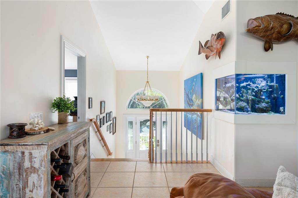 5440 95th Street Sebastian, FL 32958 - Photo 7 of 36 a living room with furniture and a chandelier