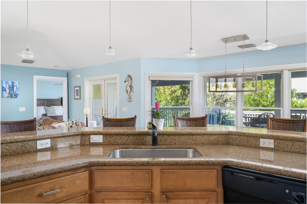 5440 95th Street Sebastian, FL 32958 - Photo 9 of 36 a kitchen with granite countertop a sink and a window