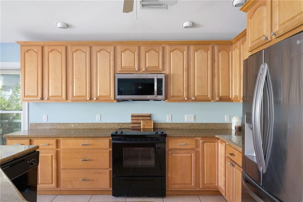 5440 95th Street Sebastian, FL 32958 - Photo 10 of 36 a kitchen with a refrigerator stove and sink