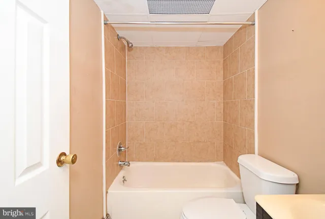 a bathroom with a bathtub and a toilet