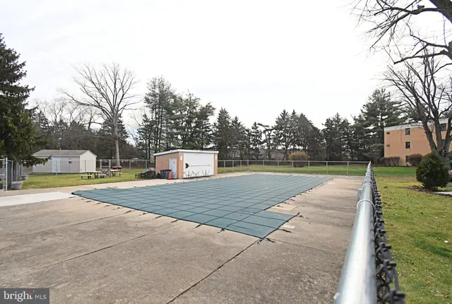 a view of a swimming pool with a yard