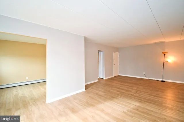 a view of an empty room with wooden floor