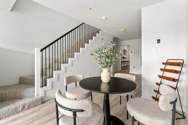 a dining room with furniture and wooden floor