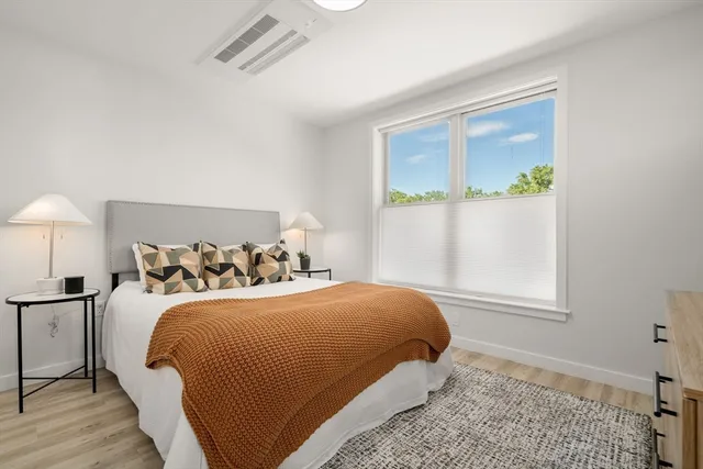 a bedroom with a bed and a window