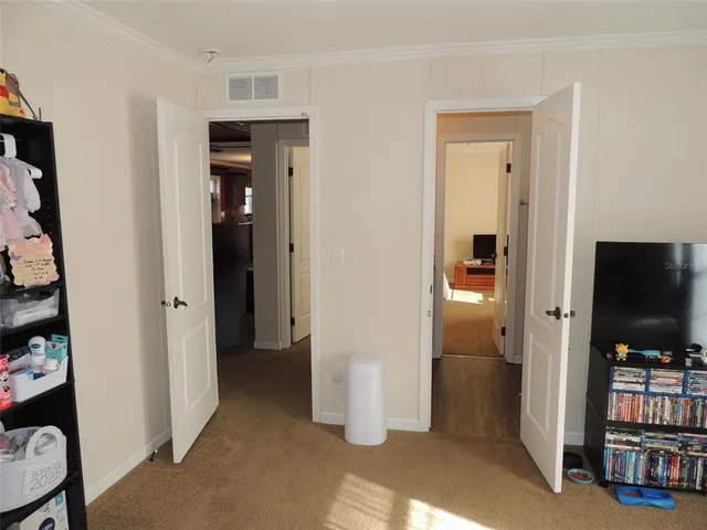 a view of a livingroom with walk in closet and bedroom