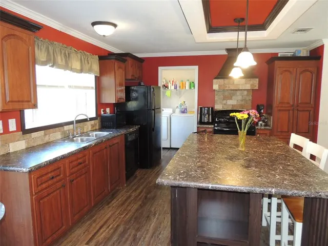 a kitchen with a stove a refrigerator and wooden cabinets