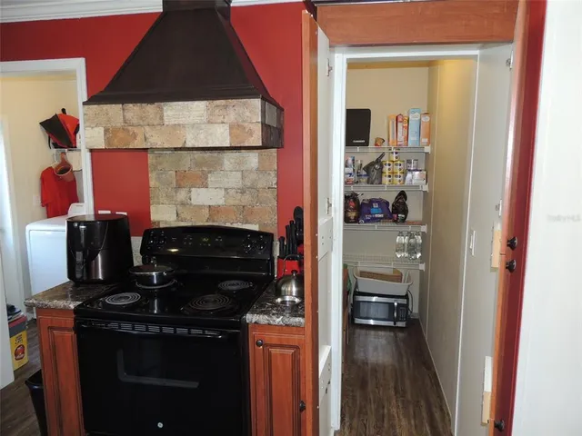 a kitchen with a refrigerator and a stove
