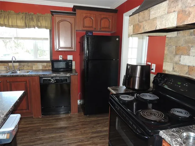 a kitchen with a stove and a refrigerator