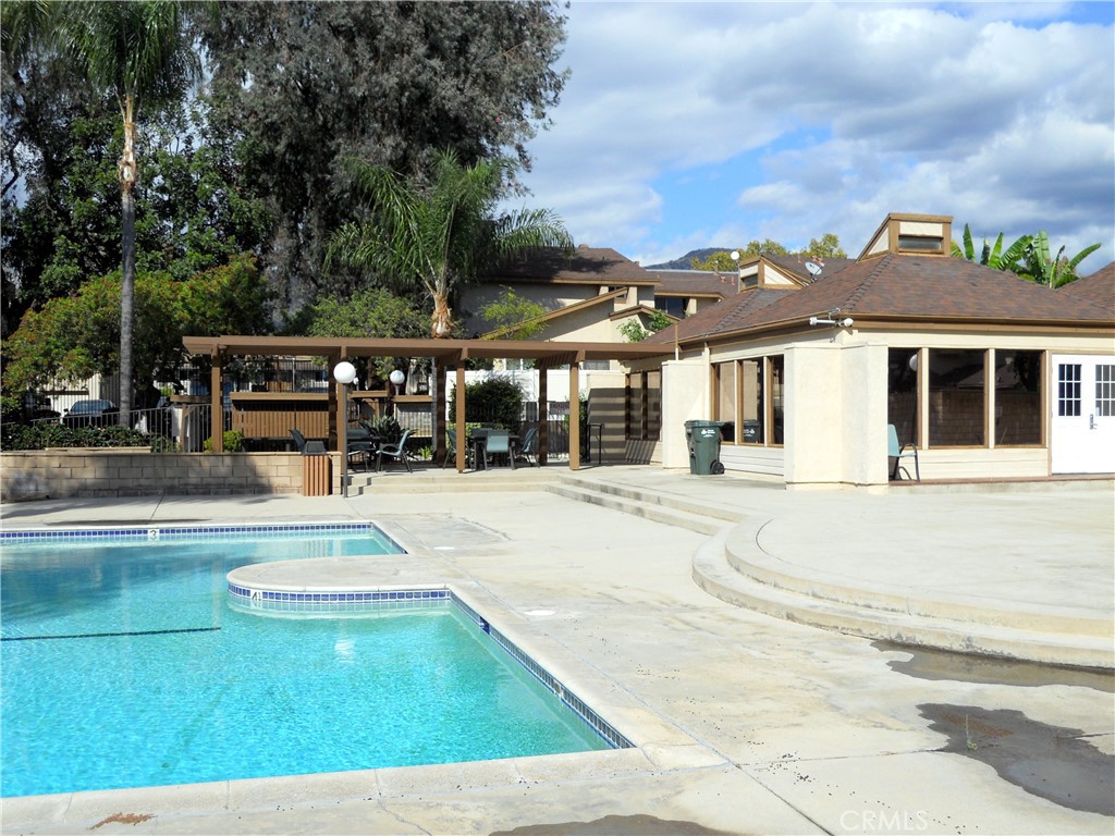 750 East 5th Street, Unit 51 Azusa, CA 91702 - Photo 42 of 59 a view of a white house with a swimming pool