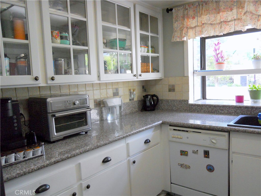 750 East 5th Street, Unit 51 Azusa, CA 91702 - Photo 5 of 59 a kitchen with granite countertop a sink and a window