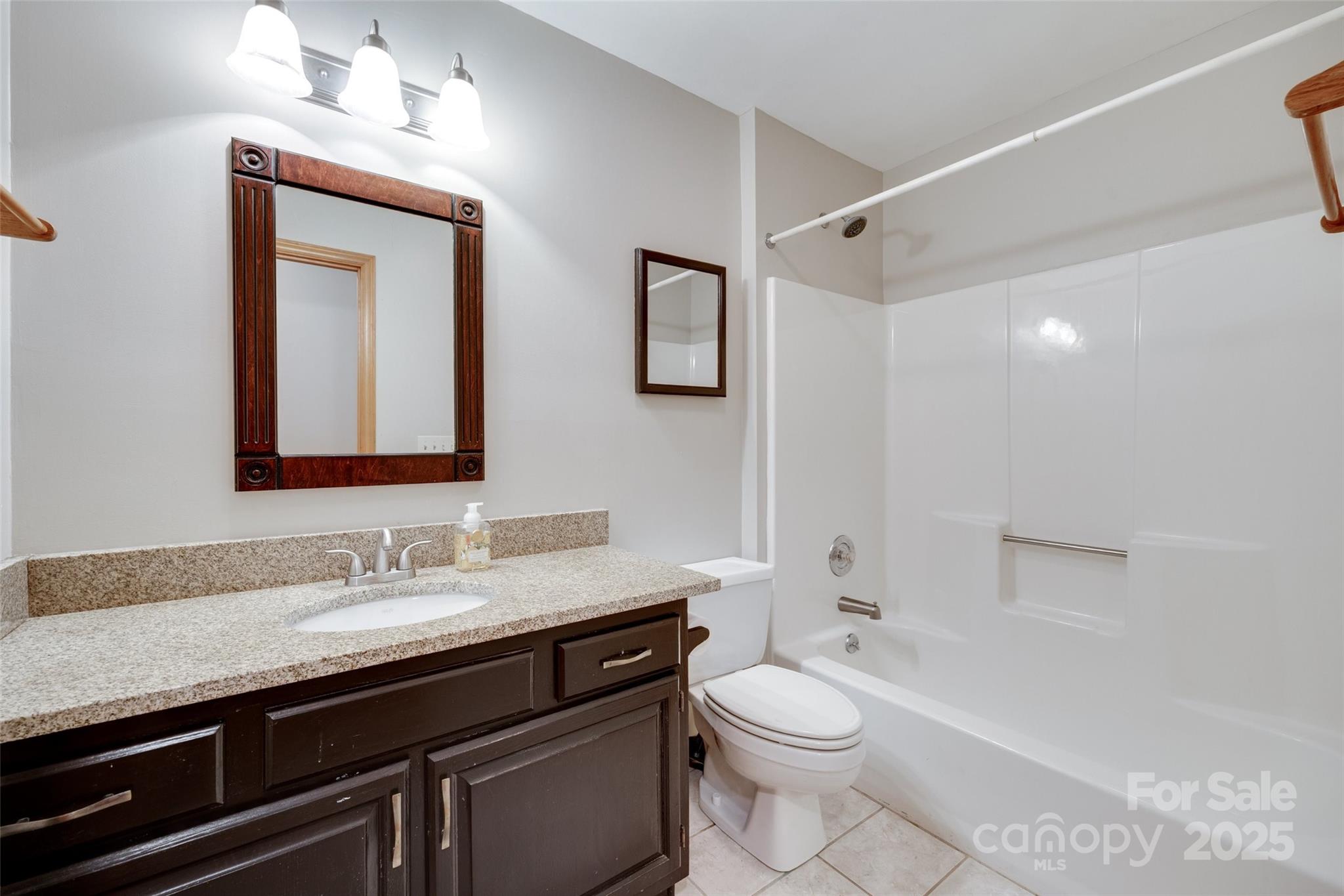 25056 Timberlake Drive Fort Mill, SC 29708 - Photo 23 of 37 a bathroom with a granite countertop toilet sink and mirror