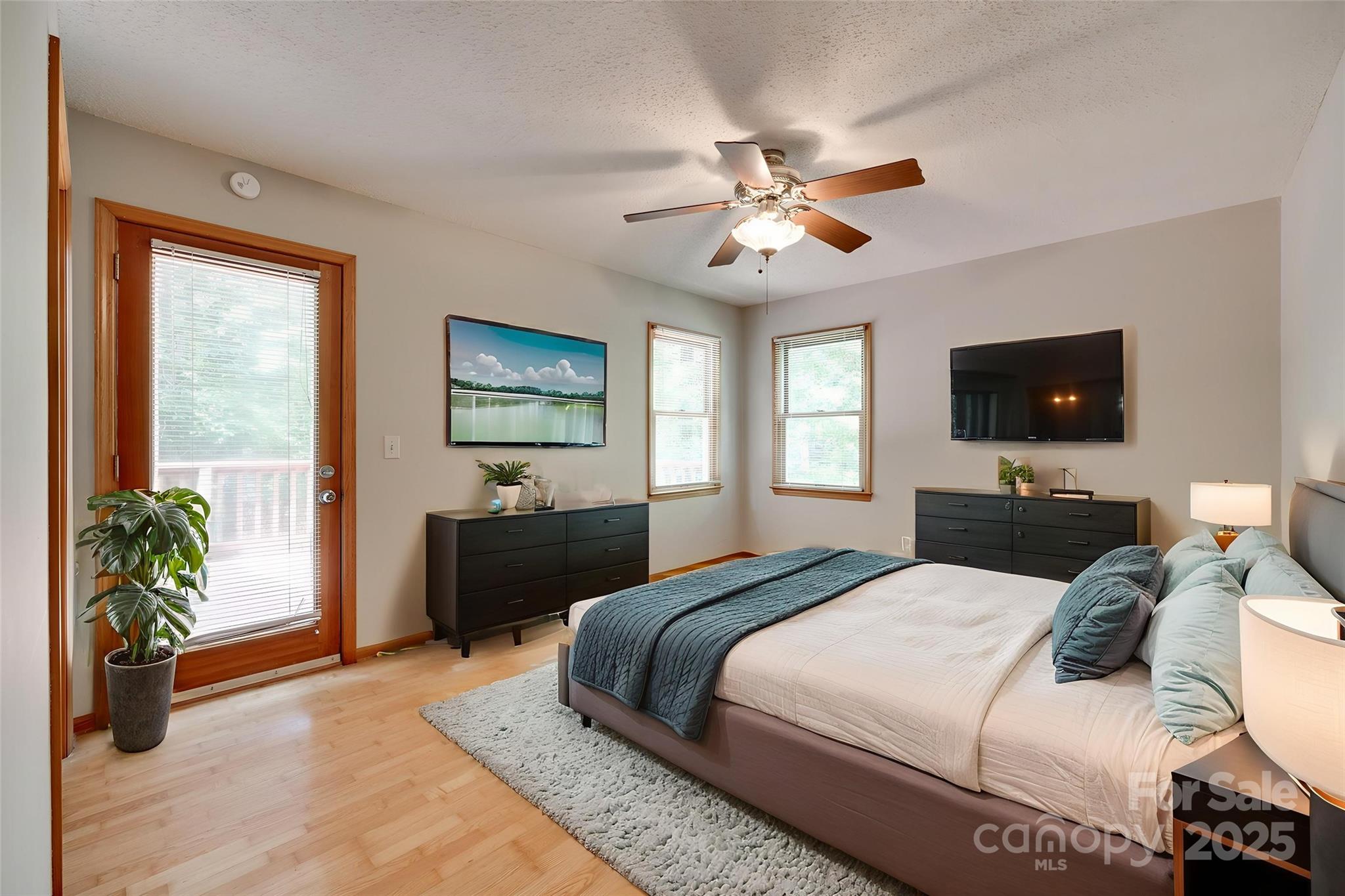 25056 Timberlake Drive Fort Mill, SC 29708 - Photo 3 of 37 a bedroom with a large bed and a chandelier