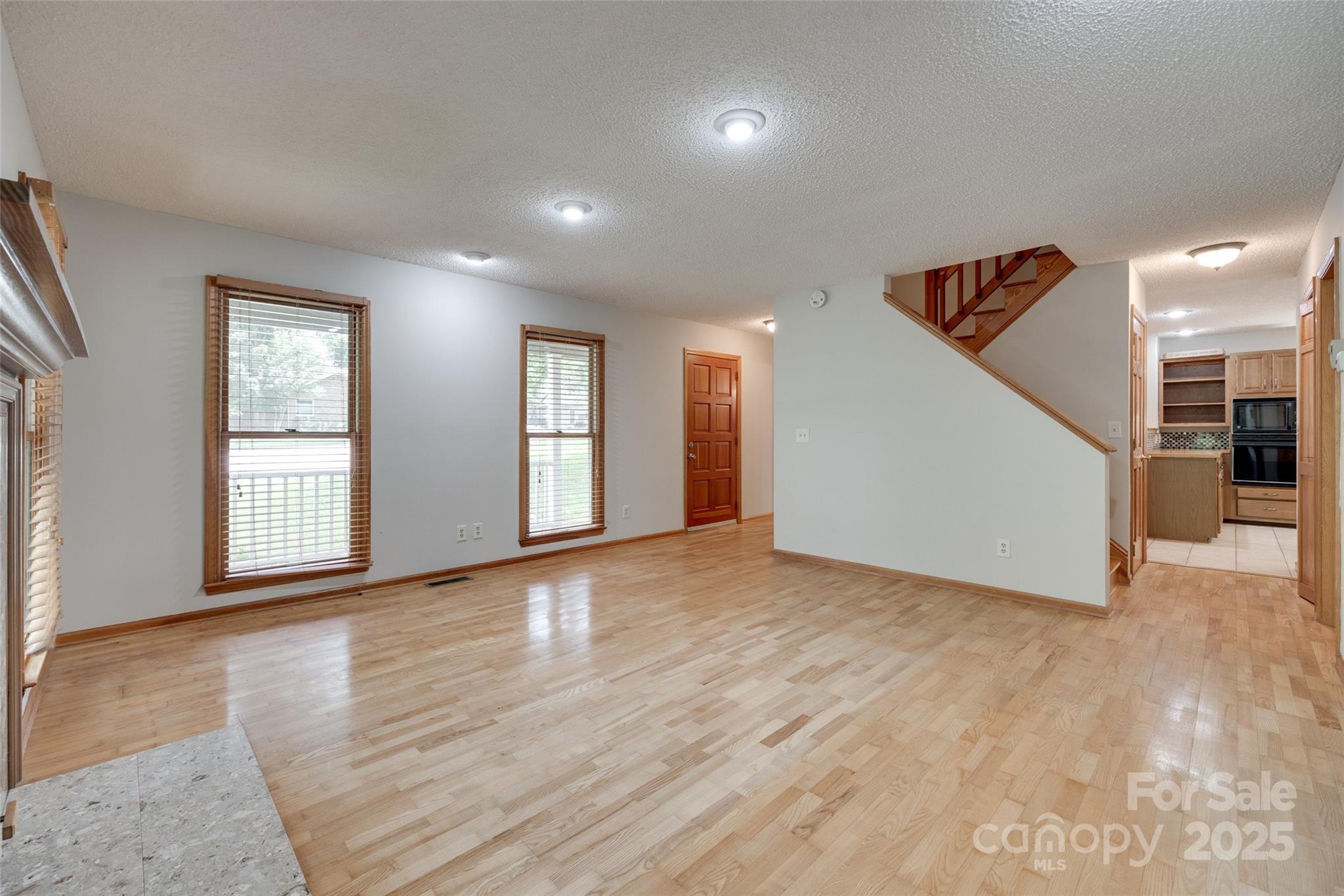 25056 Timberlake Drive Fort Mill, SC 29708 - Photo 31 of 37 an empty room with wooden floor and windows