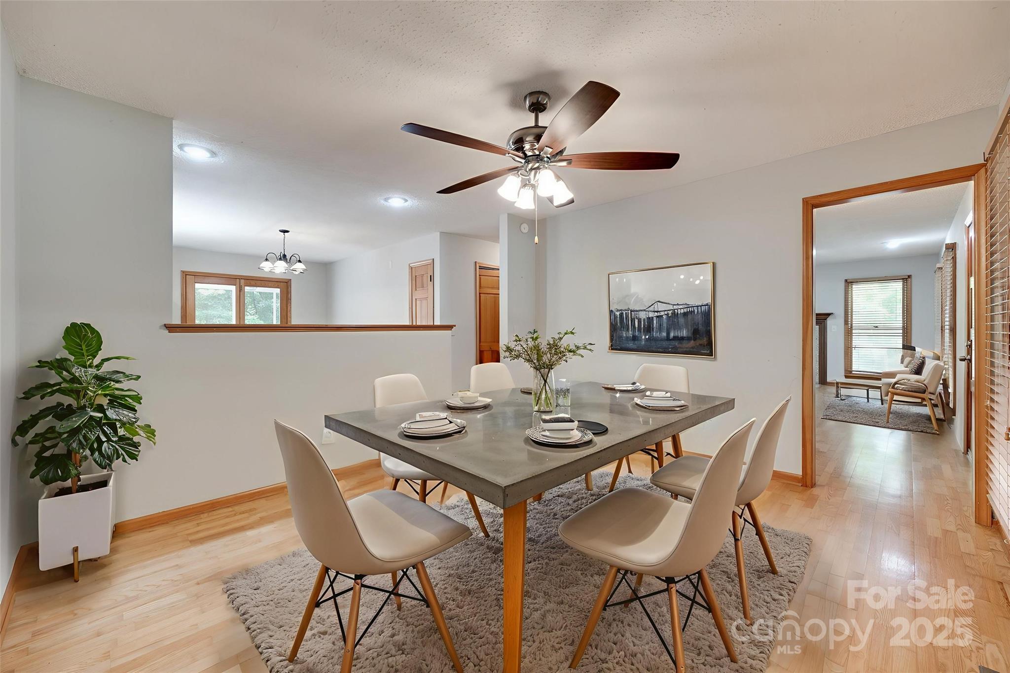 25056 Timberlake Drive Fort Mill, SC 29708 - Photo 4 of 37 a view of a dining room and livingroom with furniture wooden floor a chandelier