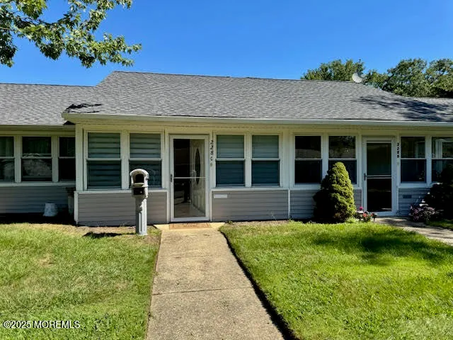 a view of a house with sitting area and garden