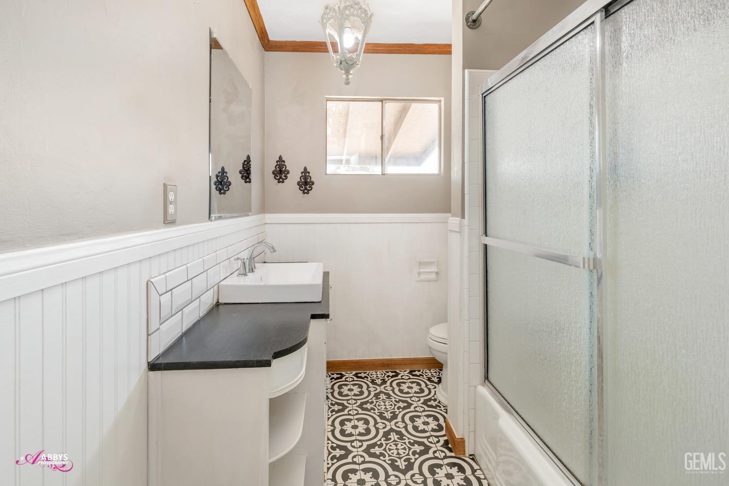 Undisclosed Address Bakersfield, CA 93309 - Photo 12 of 21 a bathroom with a sink and a mirror