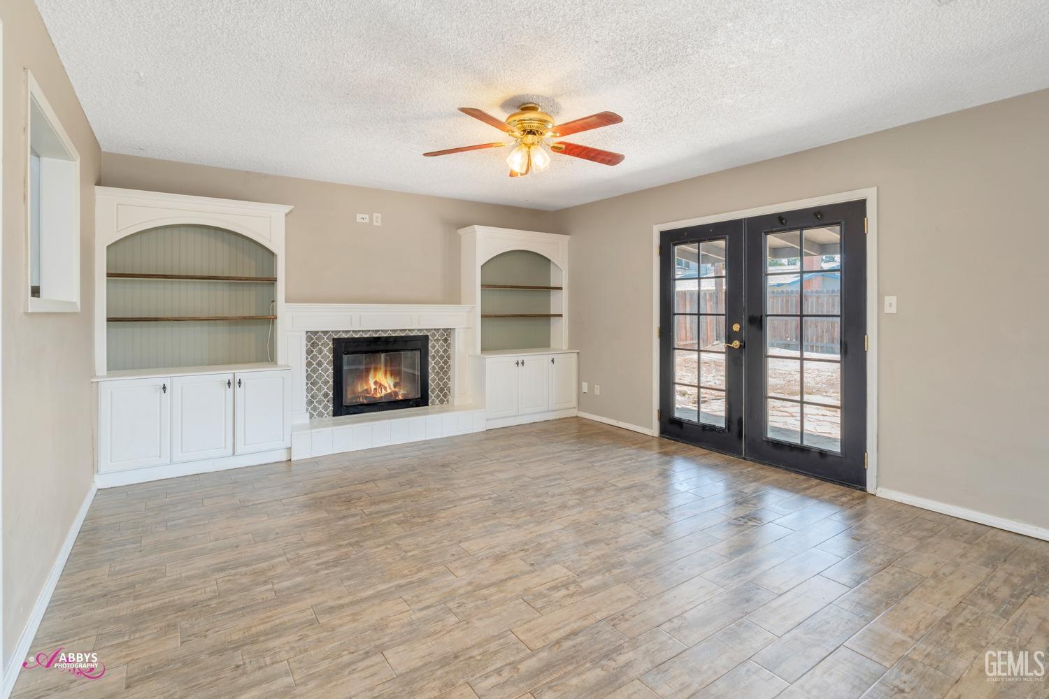 Undisclosed Address Bakersfield, CA 93309 - Photo 20 of 21 a view of an empty room with wooden floor fireplace and a window