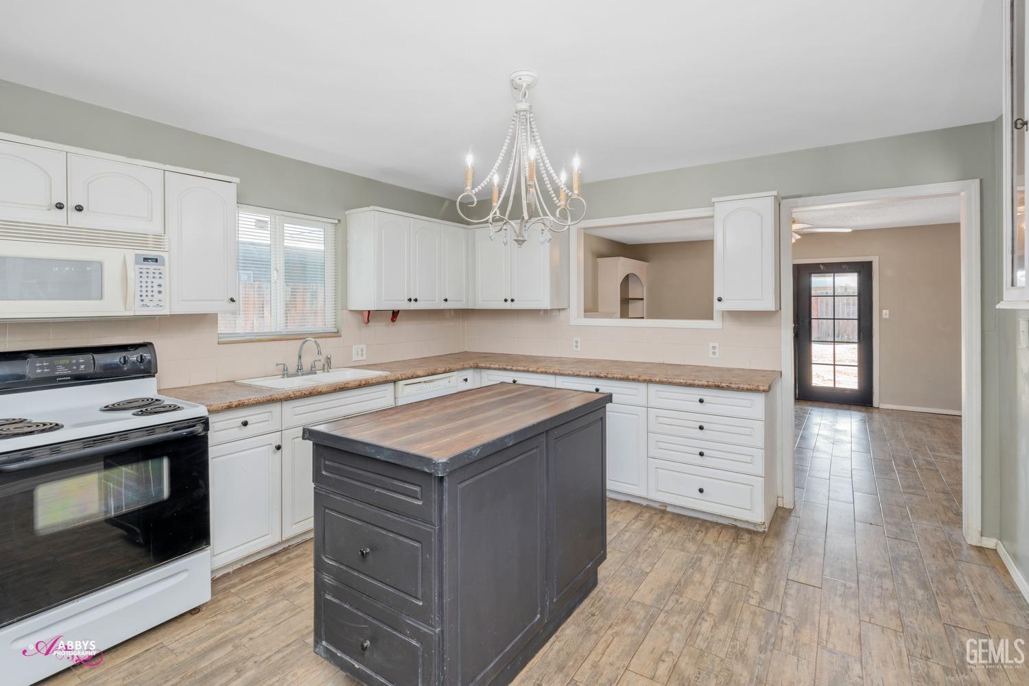 Undisclosed Address Bakersfield, CA 93309 - Photo 21 of 21 a kitchen with a sink stove and cabinets
