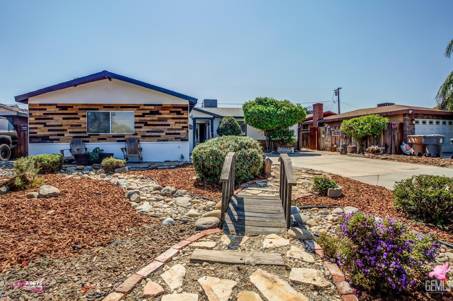 Undisclosed Address Bakersfield, CA 93309 - Photo 3 of 21 a front view of a house with garden