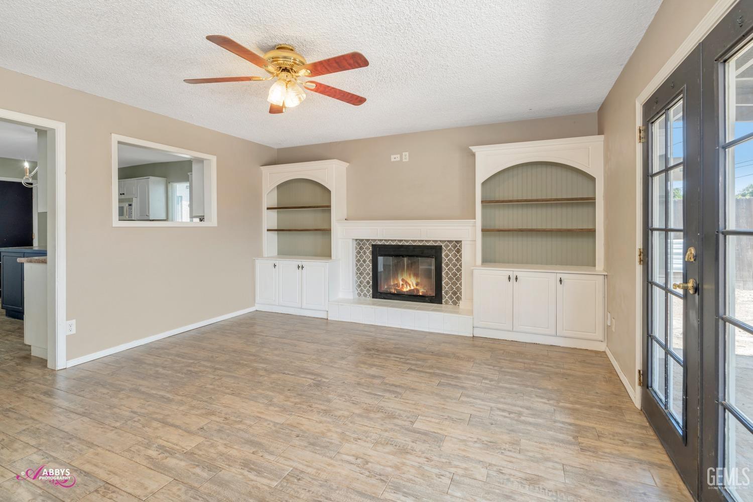 Undisclosed Address Bakersfield, CA 93309 - Photo 4 of 21 a view of an empty room with a fireplace and a window
