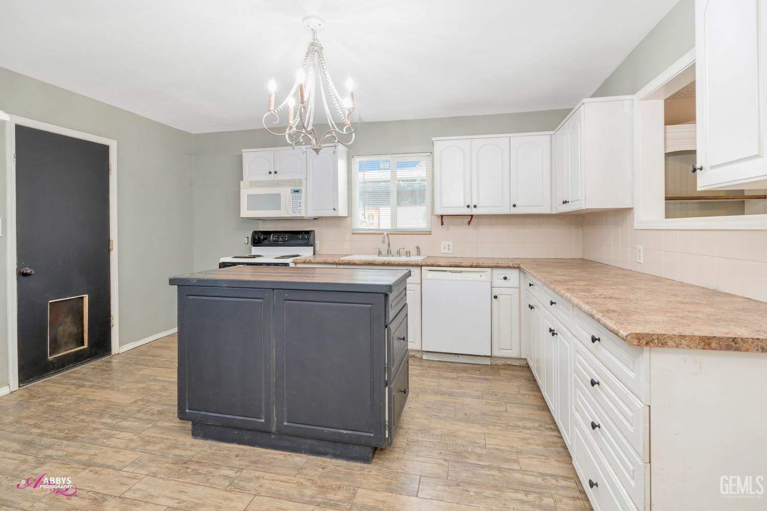 Undisclosed Address Bakersfield, CA 93309 - Photo 5 of 21 a kitchen with stainless steel appliances granite countertop a stove top oven a sink dishwasher and a refrigerator with wooden floor