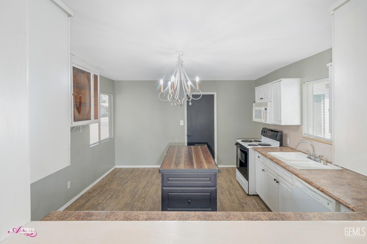 Undisclosed Address Bakersfield, CA 93309 - Photo 6 of 21 a kitchen with kitchen island granite countertop a sink stove and refrigerator