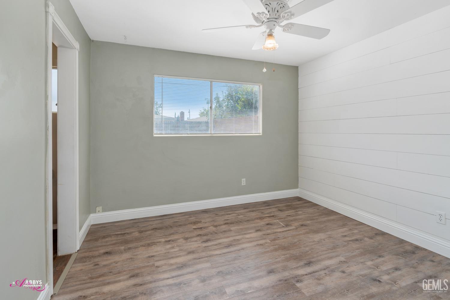 Undisclosed Address Bakersfield, CA 93309 - Photo 10 of 21 wooden floor in an empty room with a window