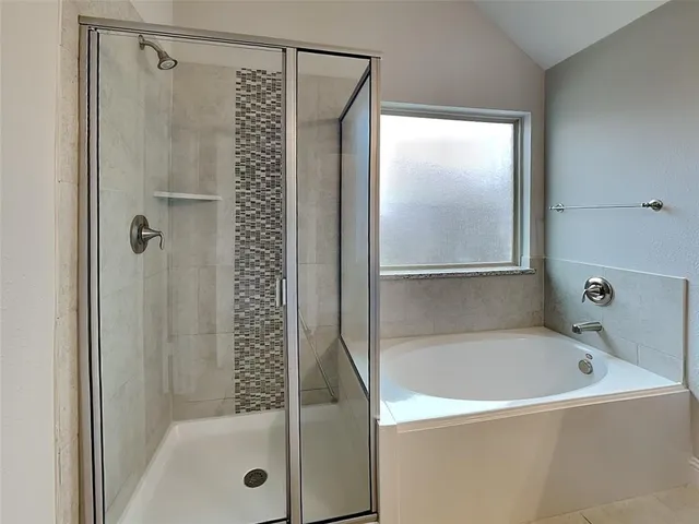 a bathroom with a bathtub and a shower