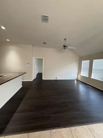 a large kitchen with kitchen island granite countertop a refrigerator and a sink