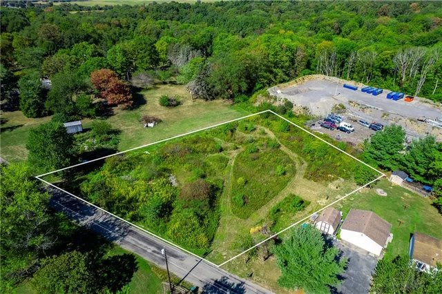 an aerial view of a residential houses with outdoor space and street view