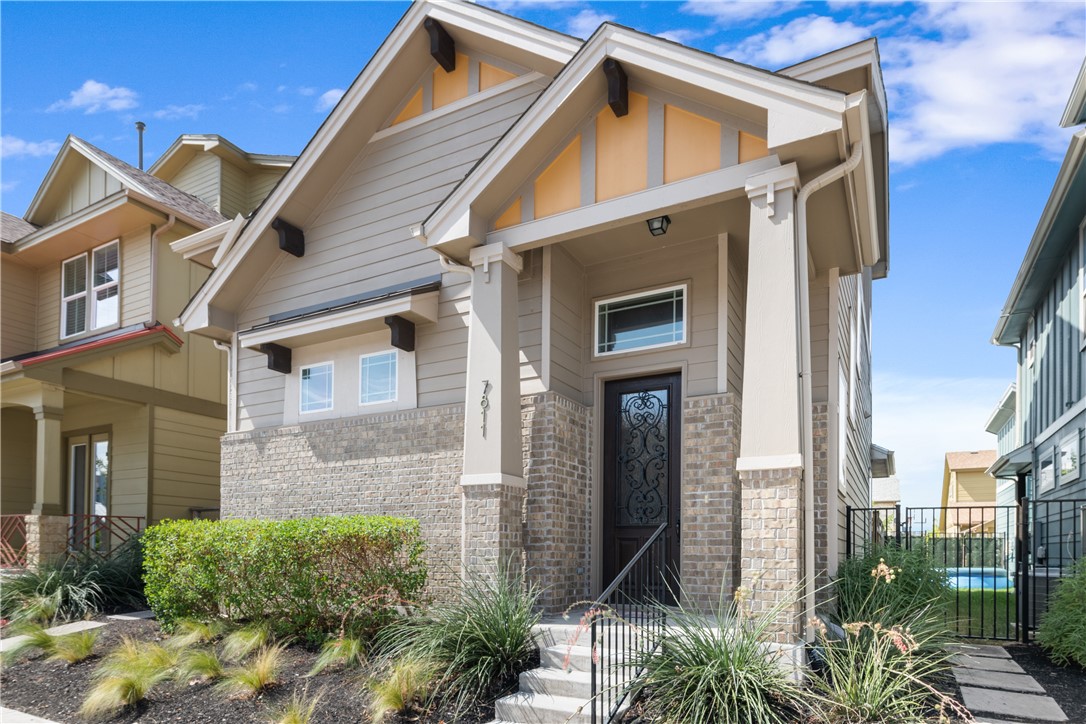 7811 Wildcat Pass Austin, TX 78757 - Photo 1 of 24 a front view of a house with a yard