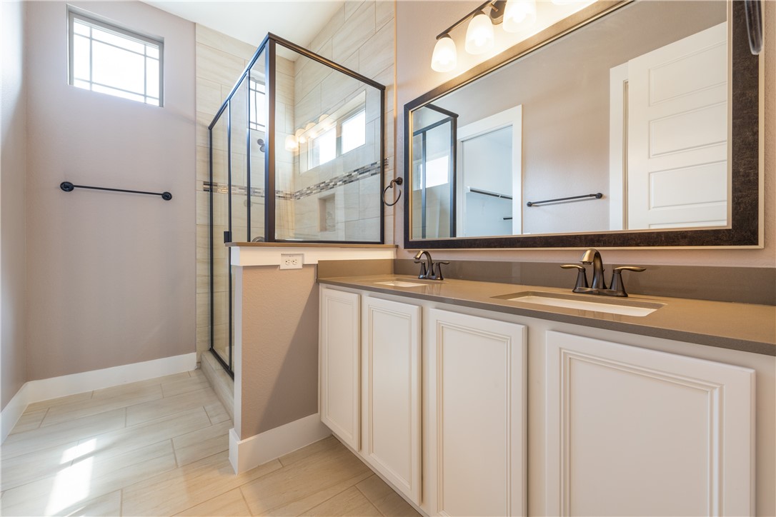 7811 Wildcat Pass Austin, TX 78757 - Photo 11 of 24 a bathroom with a double vanity sink and a mirror