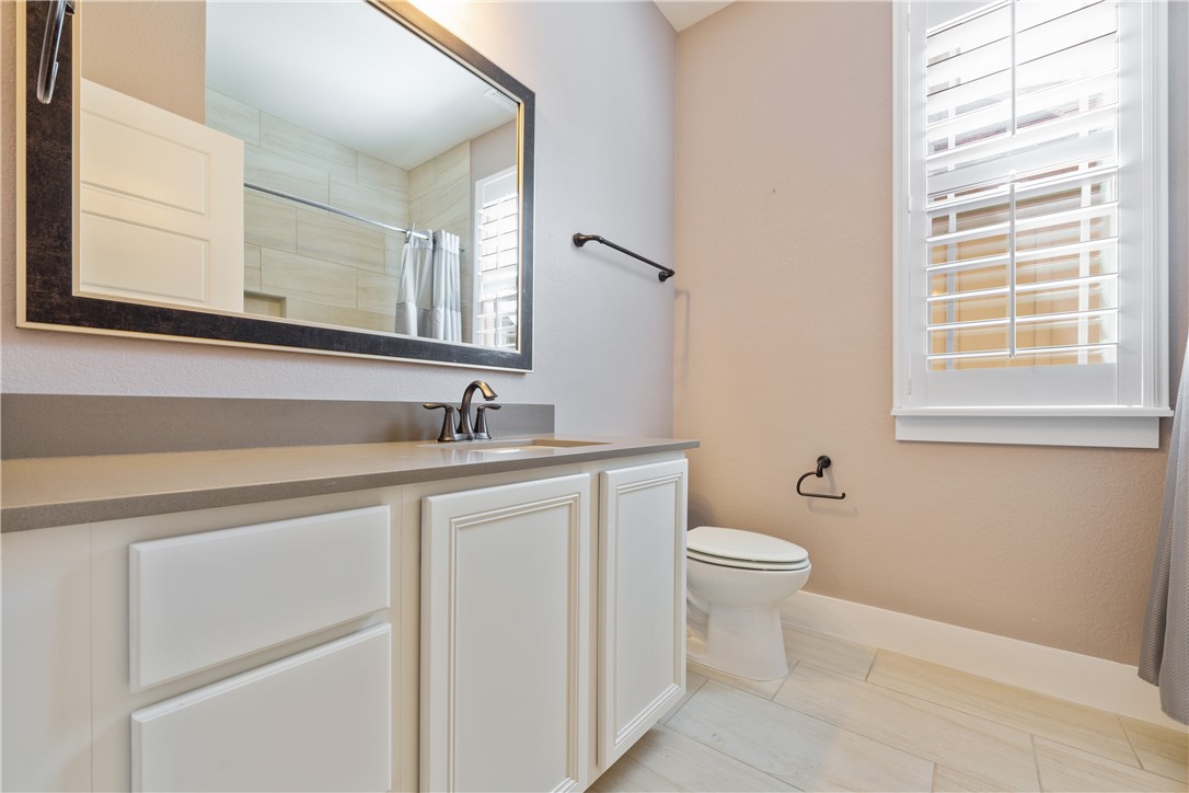 7811 Wildcat Pass Austin, TX 78757 - Photo 15 of 24 a bathroom with a toilet sink and mirror