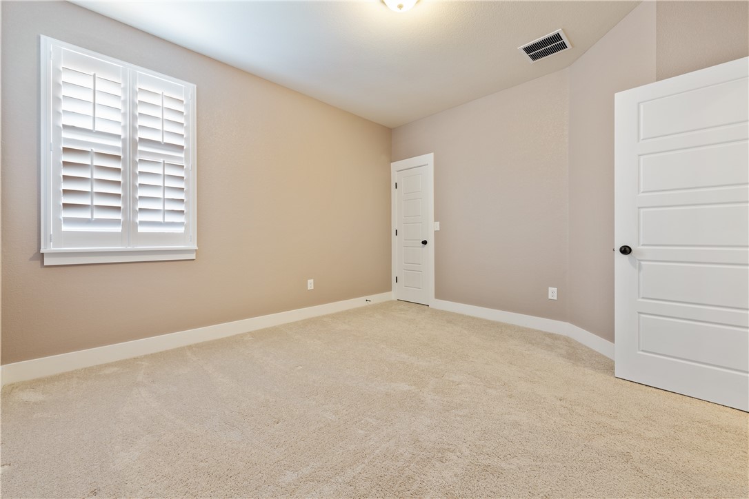 7811 Wildcat Pass Austin, TX 78757 - Photo 16 of 24 an empty room with windows and closet