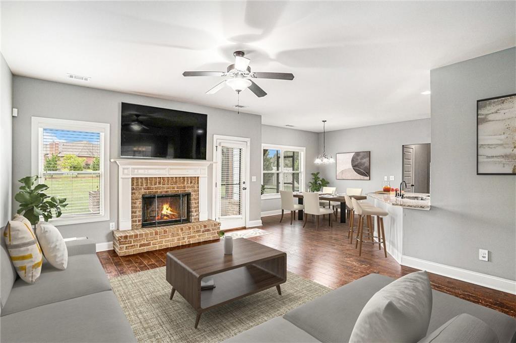 1120 Stroud Road McDonough, GA 30252 - Photo 2 of 6 a living room with furniture a flat screen tv and a fireplace