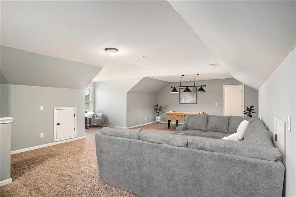 1120 Stroud Road McDonough, GA 30252 - Photo 6 of 6 a living room with furniture and a chandelier