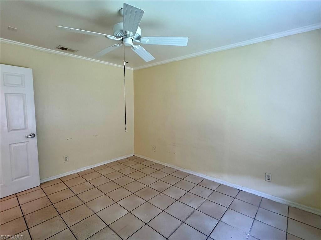 2153 Sunshine Boulevard, Unit 4 Naples, FL 34116 - Photo 19 of 19 Tiled spare room with ceiling fan and ornamental molding