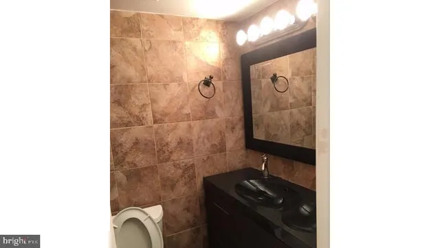a bathroom with a sink a mirror and shower