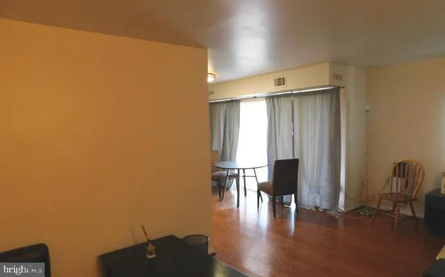 a view of room with furniture and wooden floor