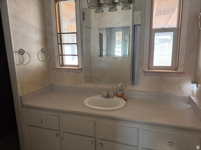 210 South State Street Moroni, UT 84646 - Photo 10 of 23 Bathroom vanity with integrated sink, flanked by two windows