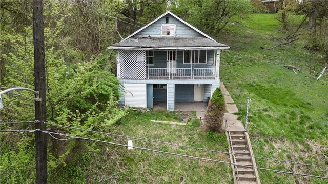 a front view of a house with plants