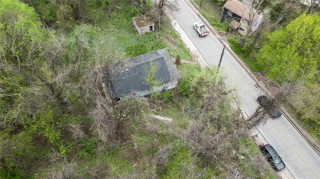 a view of a wooden house with a yard
