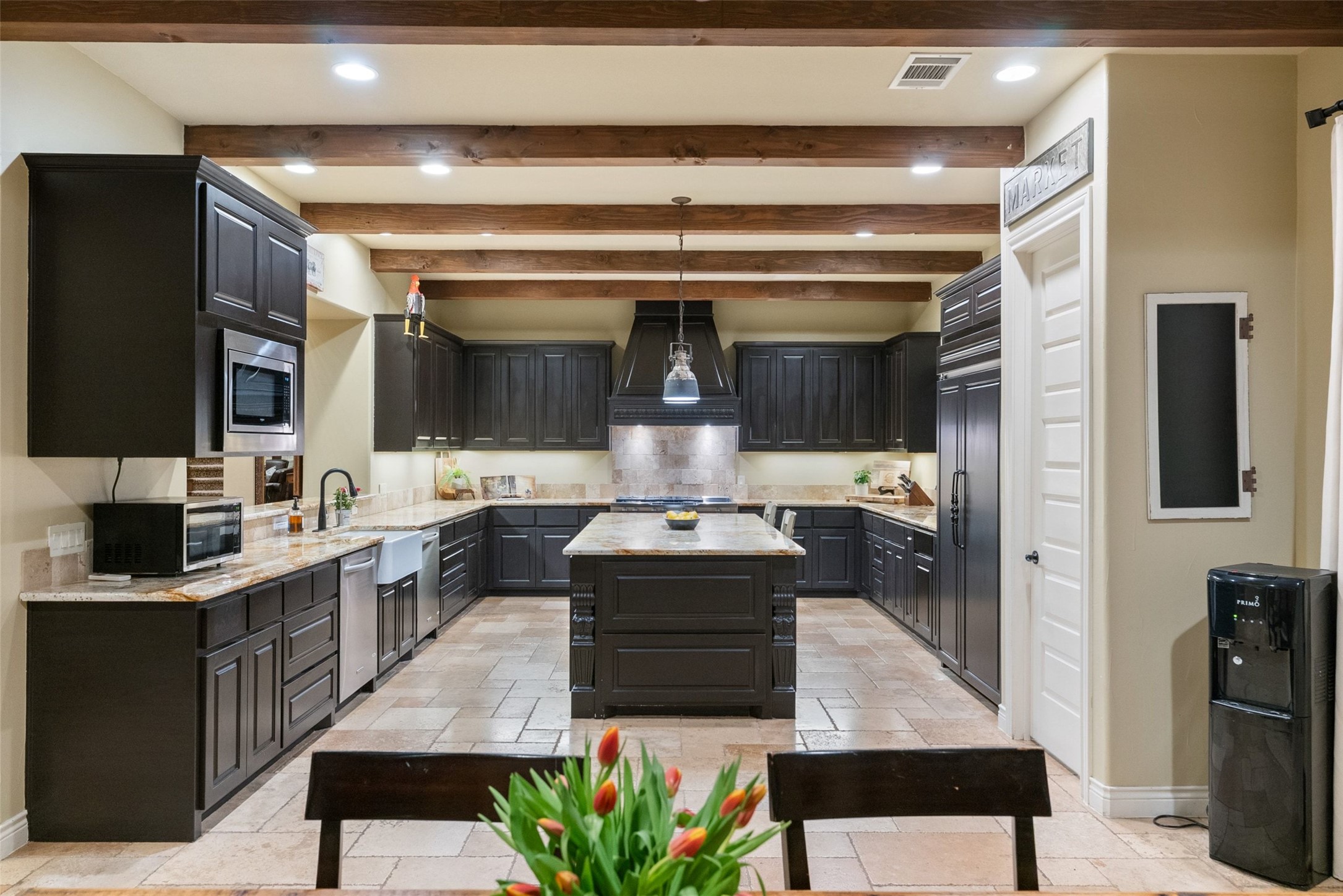 7220 Creek Road Dripping Springs, TX 78620 - Photo 12 of 40 a kitchen with kitchen island stainless steel appliances a sink stove and refrigerator