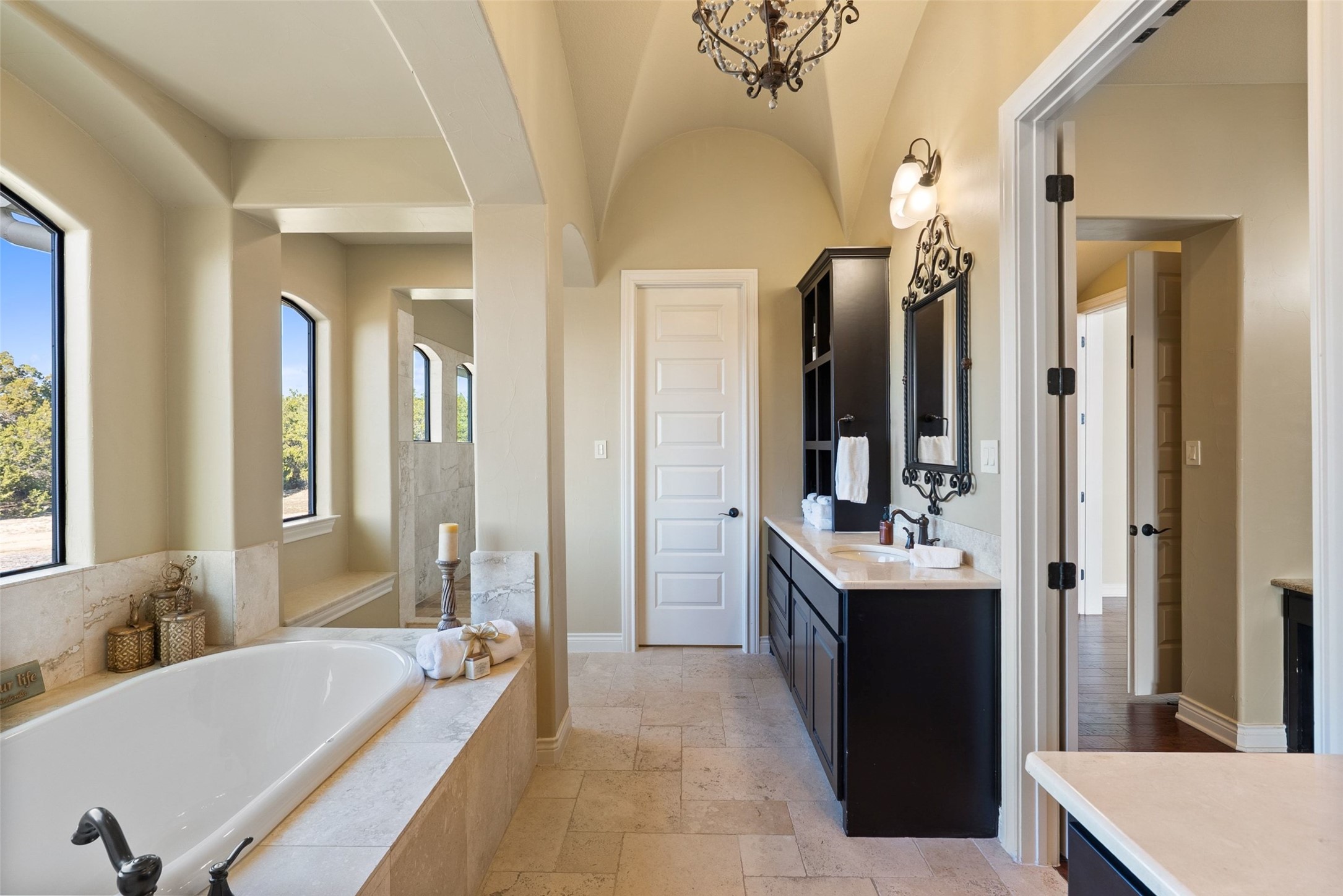7220 Creek Road Dripping Springs, TX 78620 - Photo 17 of 40 a bathroom with a tub sink and mirror