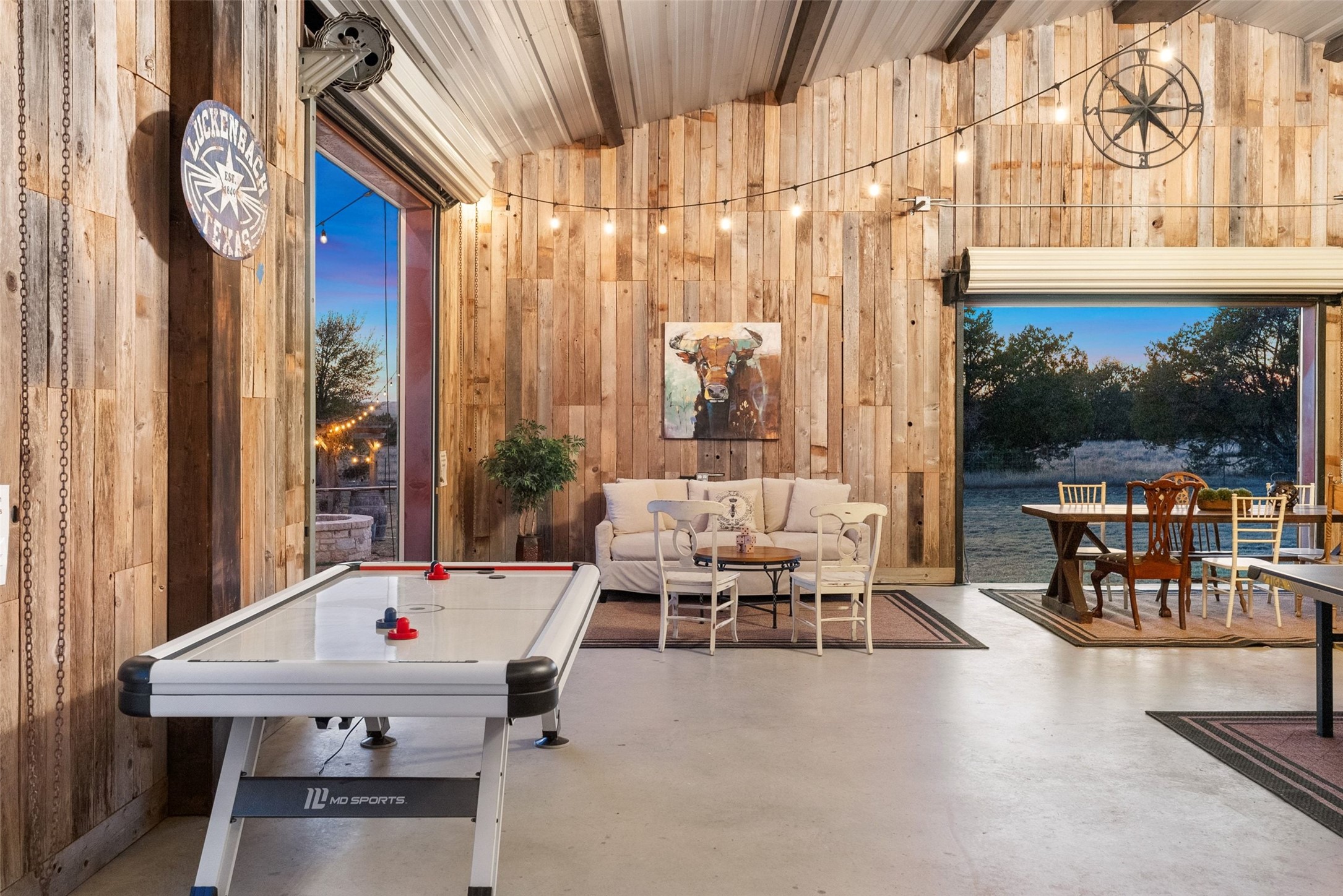 7220 Creek Road Dripping Springs, TX 78620 - Photo 23 of 40 Recreation room featuring wood walls, finished concrete flooring, and vaulted ceiling
