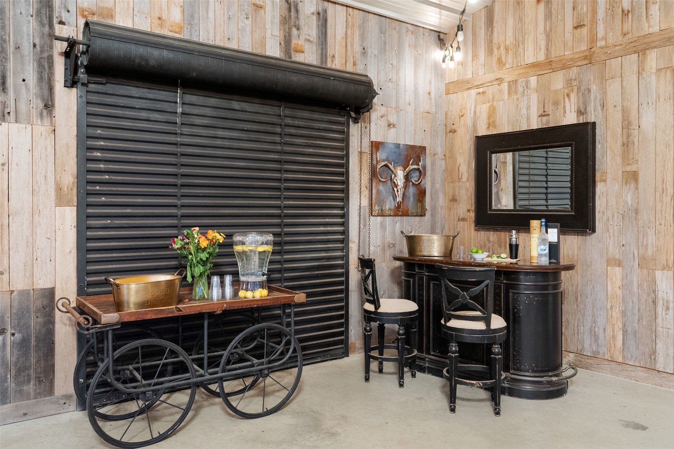 7220 Creek Road Dripping Springs, TX 78620 - Photo 24 of 40 Indoor dry bar with wooden walls and concrete floors