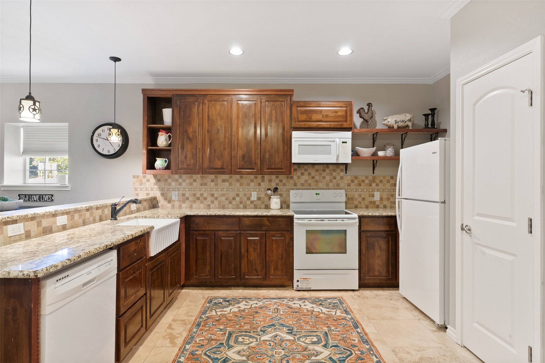 7220 Creek Road Dripping Springs, TX 78620 - Photo 32 of 40 a kitchen with a refrigerator and a sink