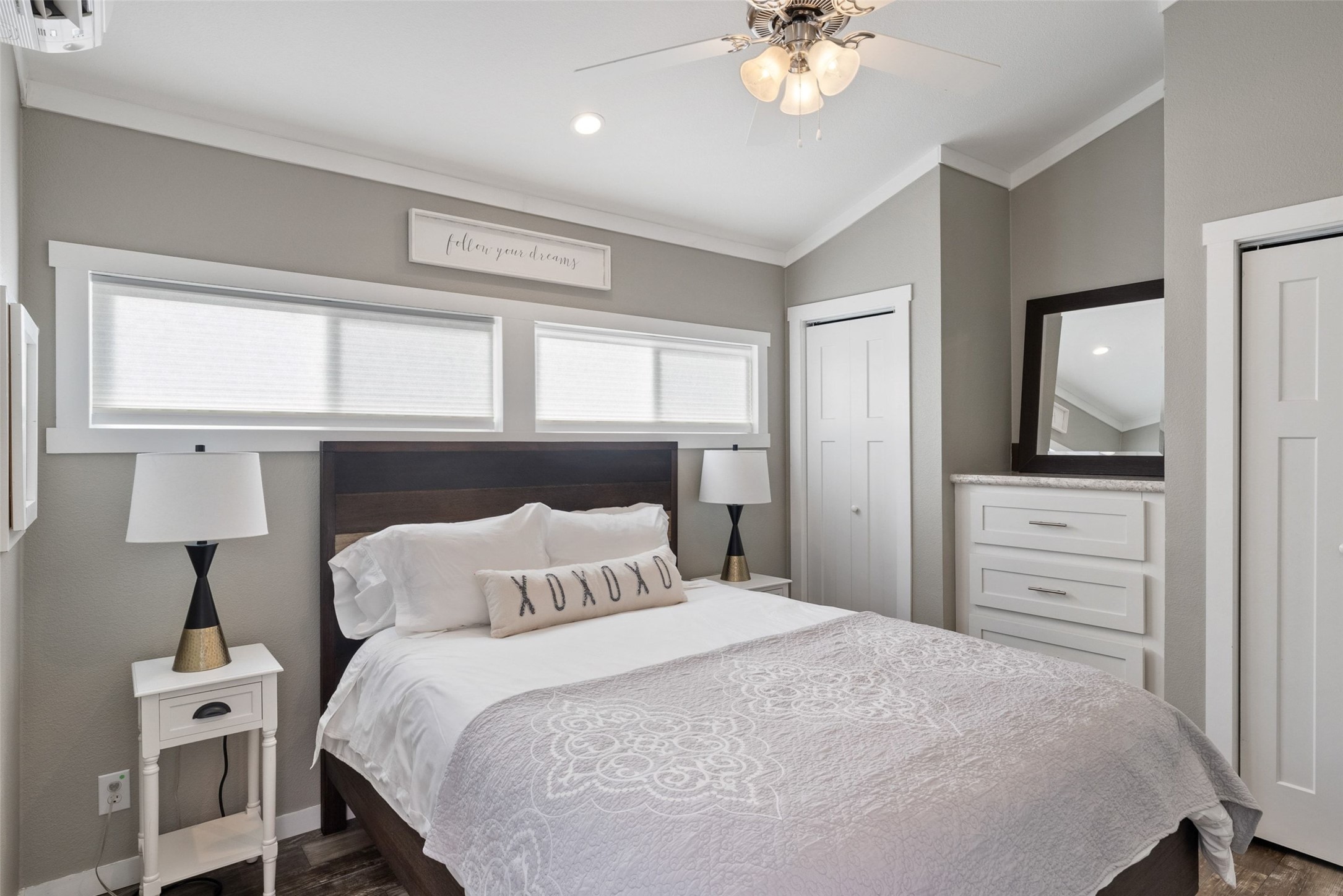 7220 Creek Road Dripping Springs, TX 78620 - Photo 35 of 40 a bedroom with a bed and a chandelier